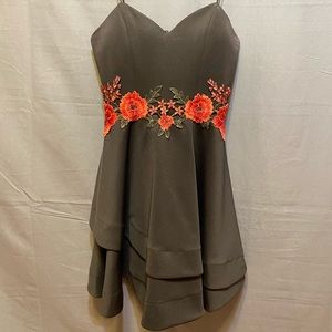 Black dress with floral embroidery around the waist. Size 7.